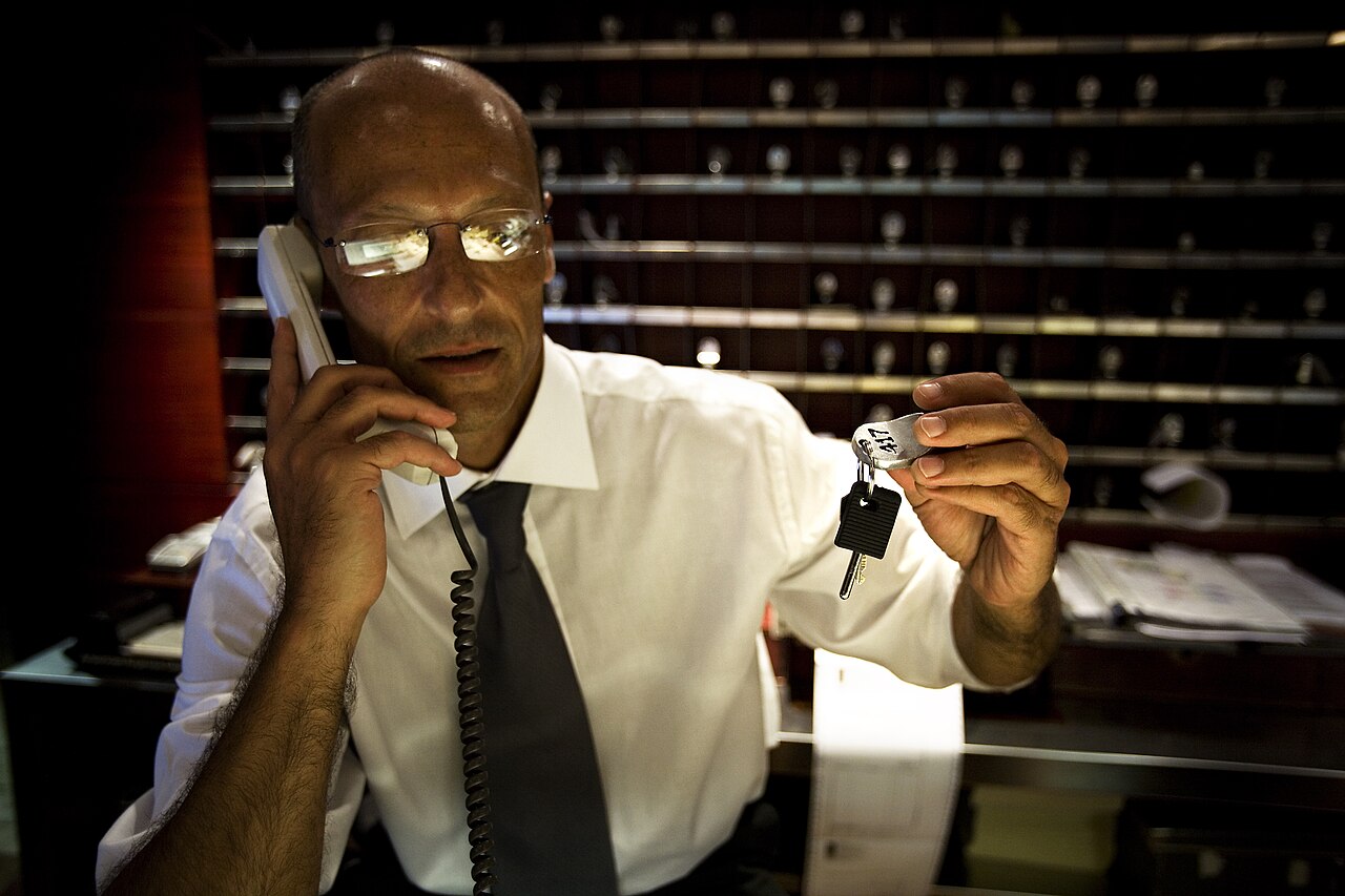 A hotel concierge handing room keys, Rome - 3566